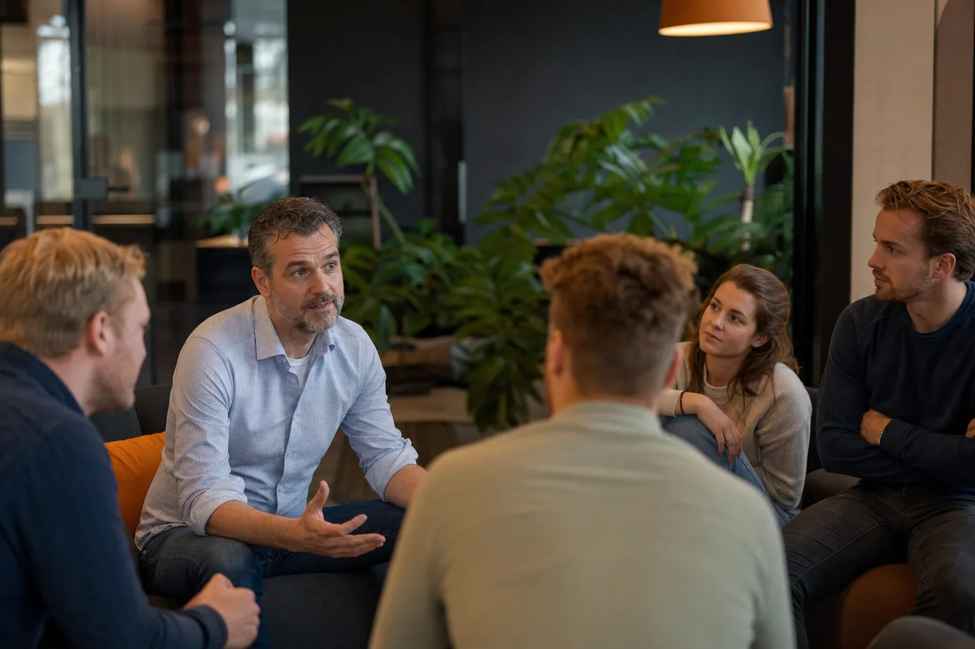 Teamcoach begeleidt een groep in een open gesprek